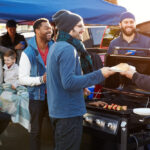 Group,Of,Sports,Fans,Tailgating,In,Stadium,Car,Park