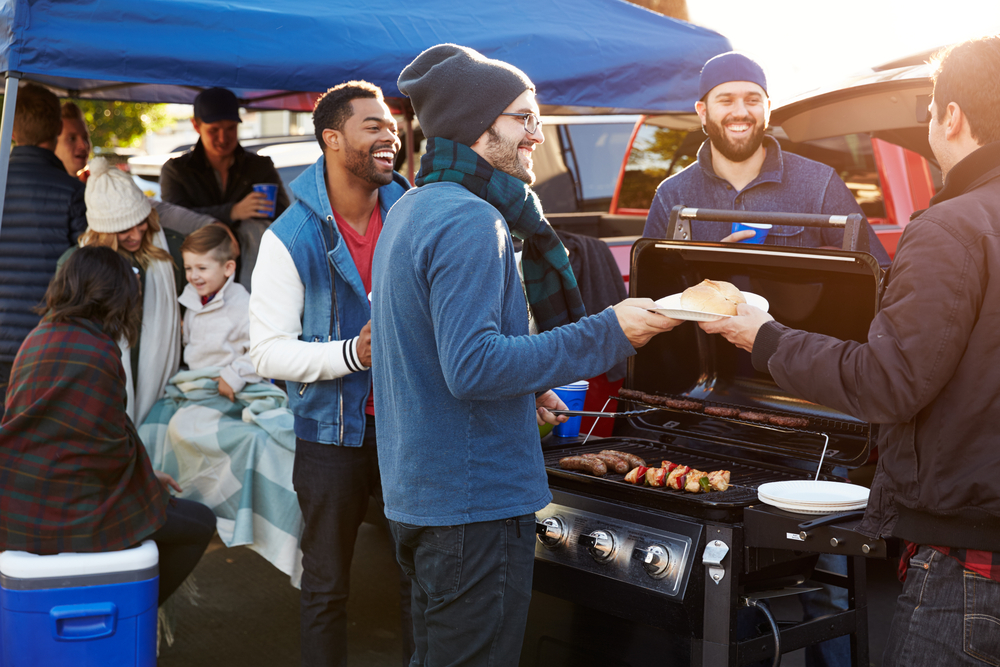 Group,Of,Sports,Fans,Tailgating,In,Stadium,Car,Park