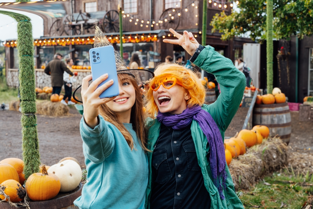 Two,Laughing,Female,Friends,In,Fun,Glasses,And,Witch,Hat