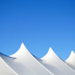 White,Canvas,Event,Tents,Against,Blue,Sky.