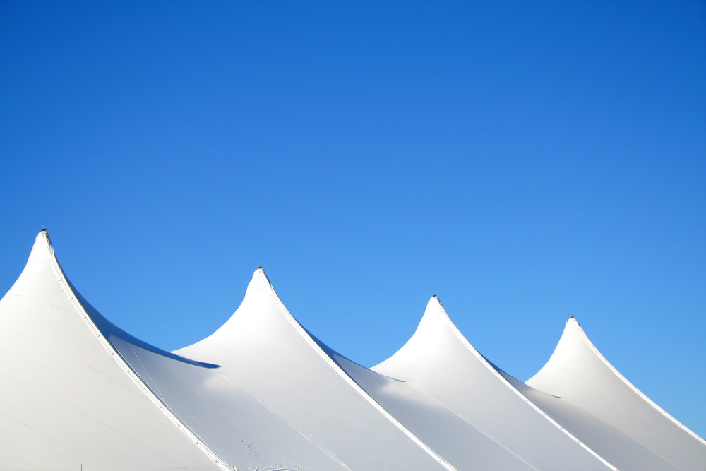 White,Canvas,Event,Tents,Against,Blue,Sky.